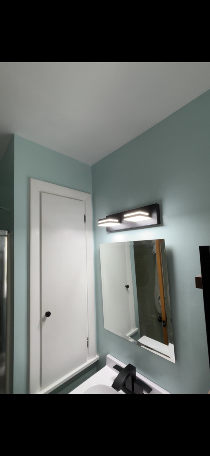 Freshly finished bathroom with new lighting and fixtures